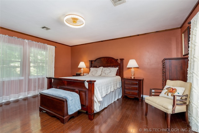 bedroom with dark wood-type flooring and crown molding