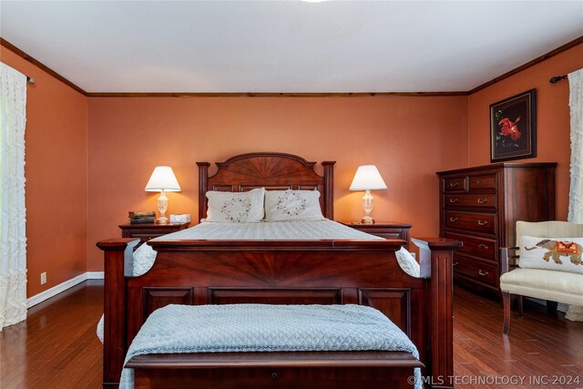 bedroom with dark hardwood / wood-style floors and crown molding