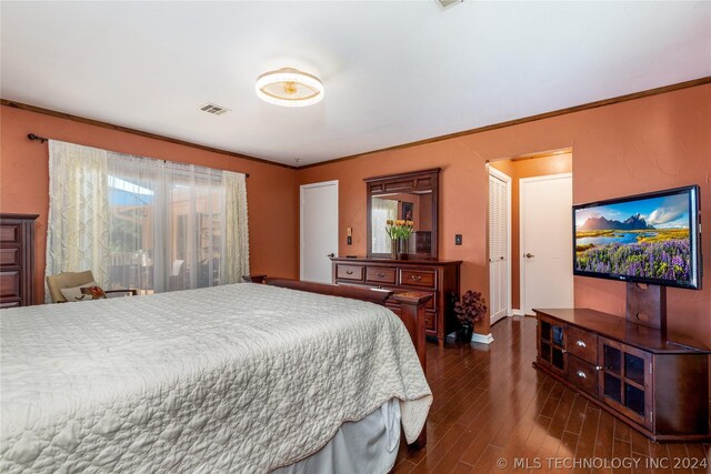 bedroom with dark hardwood / wood-style flooring