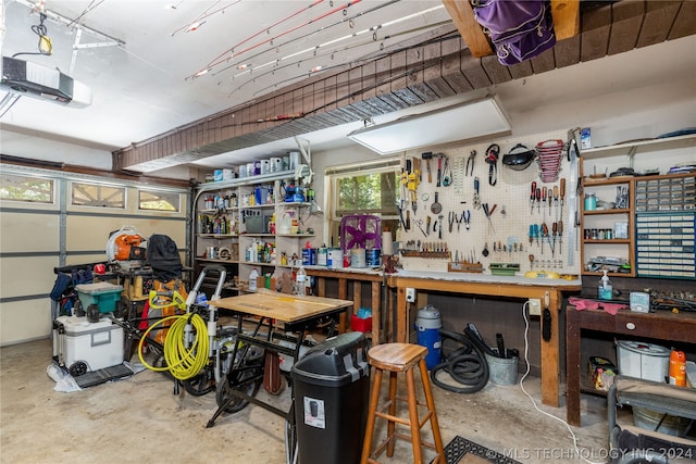 garage with a workshop area and a garage door opener