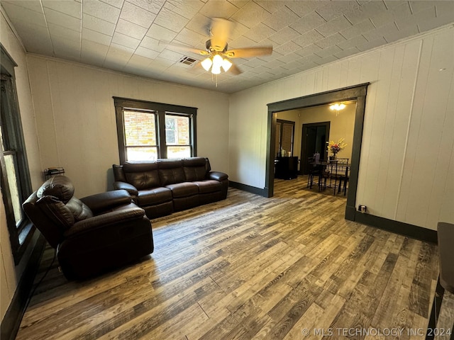 living room with ceiling fan and wood-type flooring