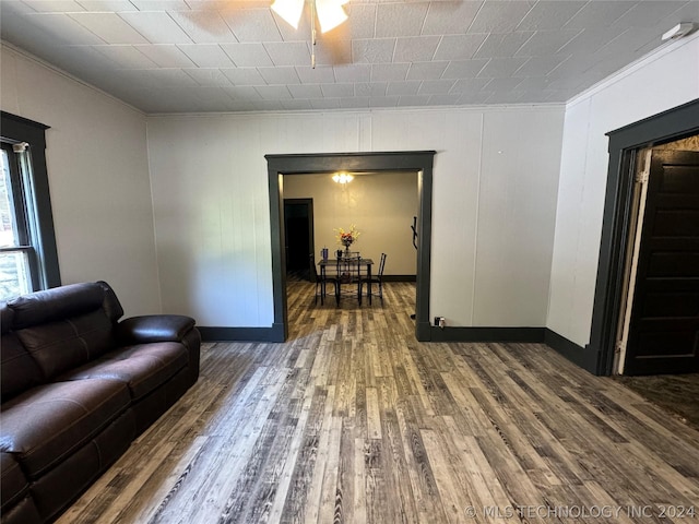 living room with crown molding and wood-type flooring