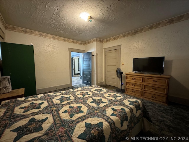 carpeted bedroom featuring a textured ceiling