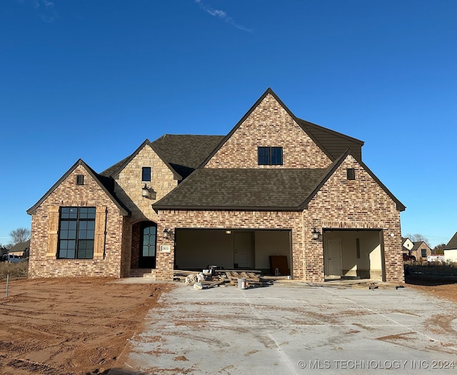 view of front of home featuring a garage and a patio