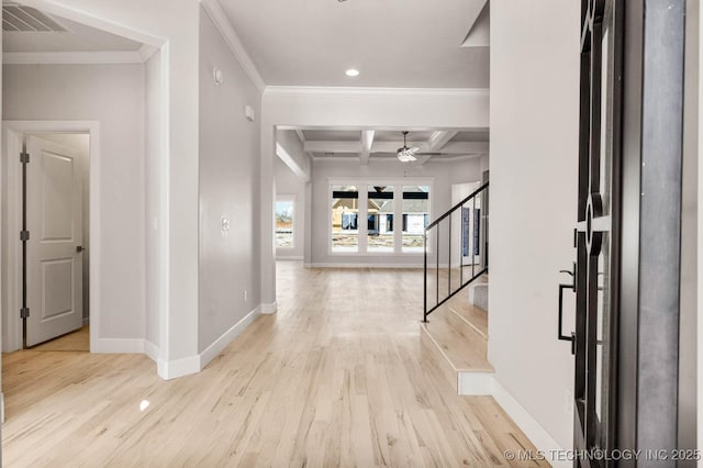 entryway with beamed ceiling, ornamental molding, coffered ceiling, and light wood-type flooring