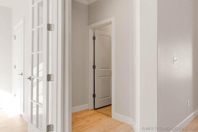 corridor with light hardwood / wood-style floors