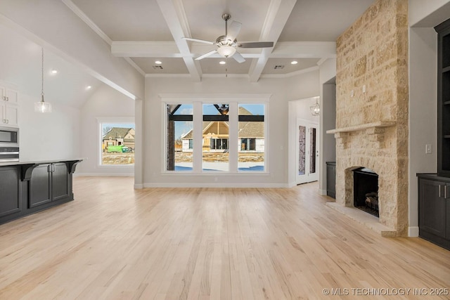 unfurnished living room with beamed ceiling, coffered ceiling, a fireplace, and light hardwood / wood-style flooring