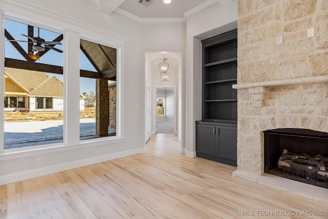 unfurnished living room featuring wood-type flooring, crown molding, ceiling fan, and built in shelves