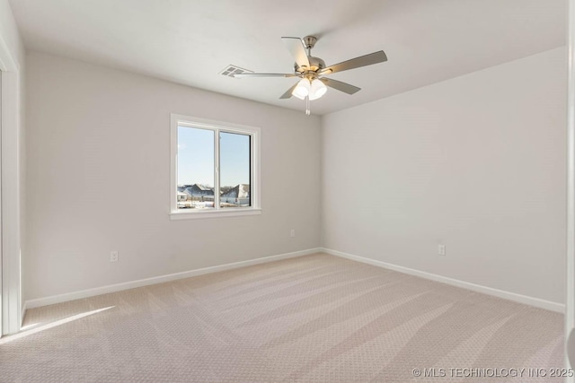 spare room with light carpet and ceiling fan