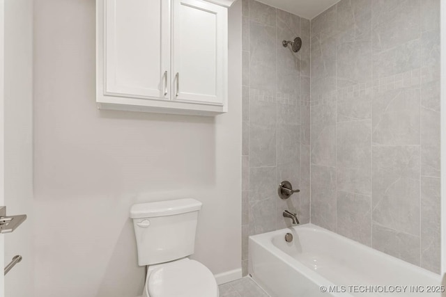 bathroom with tiled shower / bath combo and toilet