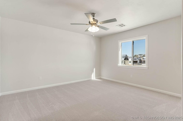 carpeted empty room featuring ceiling fan