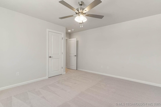 spare room with light carpet and ceiling fan