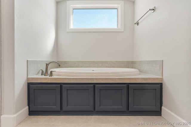 bathroom with a bathing tub and tile patterned flooring