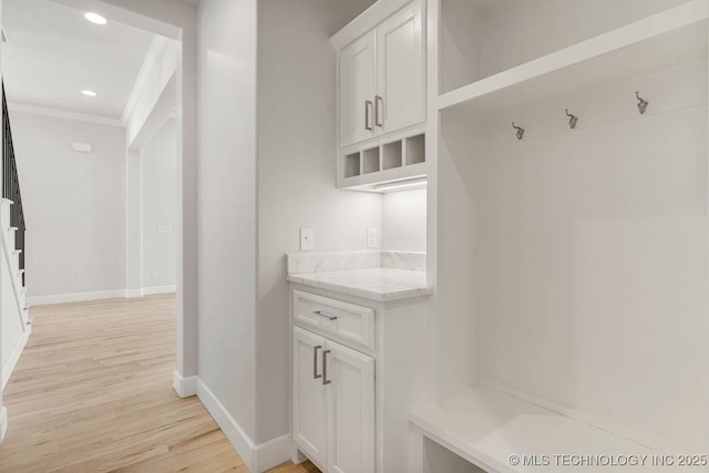 mudroom with crown molding and light hardwood / wood-style flooring