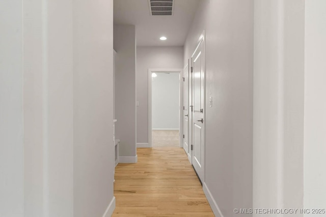 hallway with light hardwood / wood-style flooring