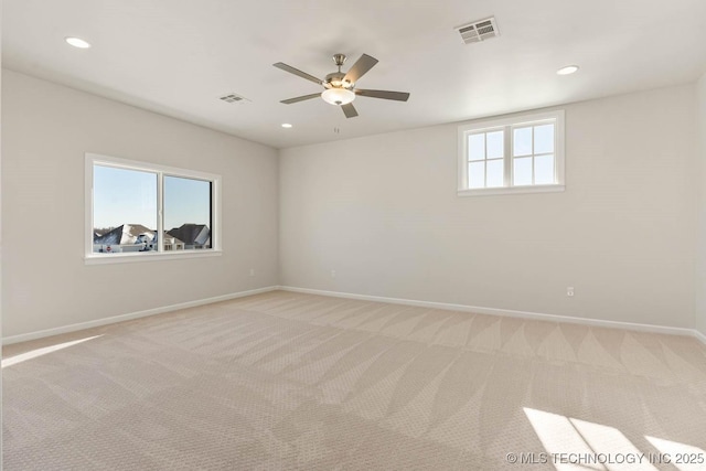 carpeted spare room with ceiling fan