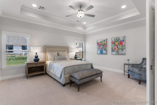 bedroom featuring baseboards, light colored carpet, and a raised ceiling
