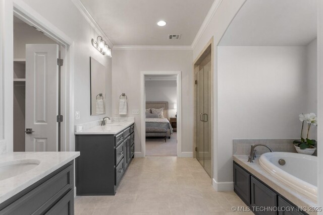 bathroom with ornamental molding, visible vents, two vanities, and a sink