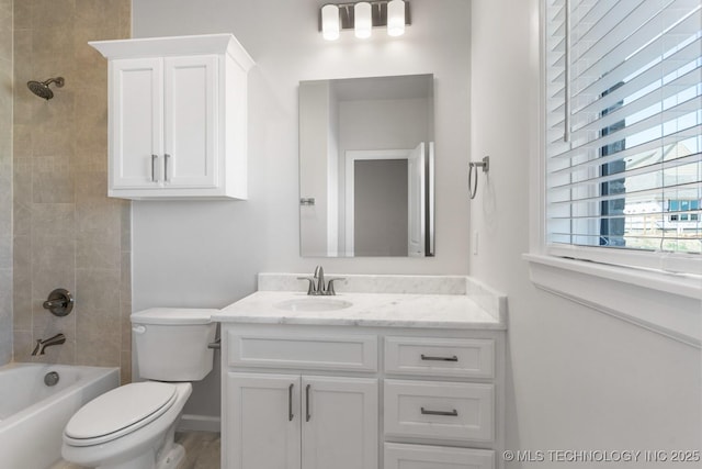 bathroom with toilet, bathing tub / shower combination, and vanity