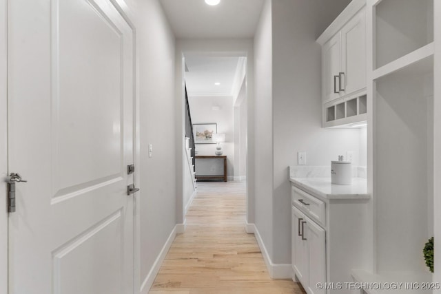 hallway with baseboards and light wood-style flooring