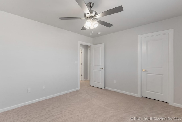 unfurnished bedroom with baseboards, a ceiling fan, and light colored carpet