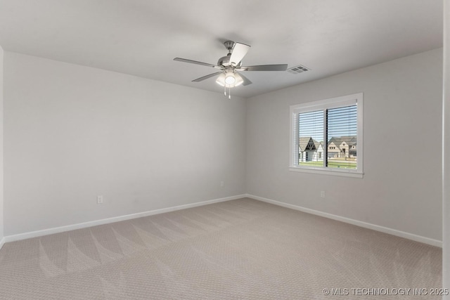 unfurnished room with baseboards, light carpet, a ceiling fan, and visible vents