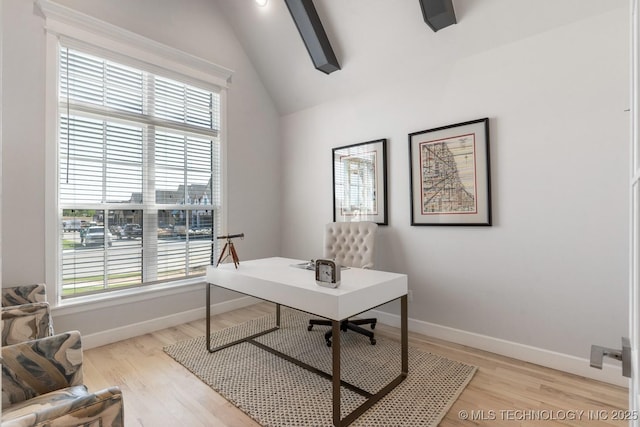 home office featuring baseboards, light wood finished floors, and lofted ceiling