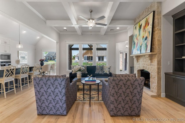 living area with a fireplace, beamed ceiling, ceiling fan, recessed lighting, and light wood finished floors