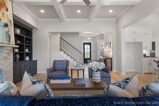 living area with crown molding, beam ceiling, and light wood-style floors