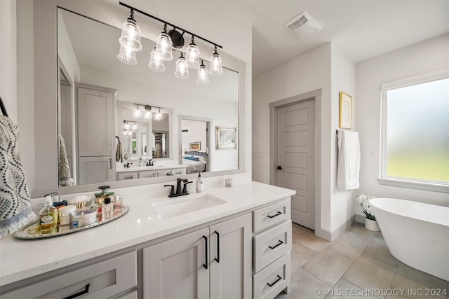 bathroom featuring tile flooring, vanity, and a bathing tub