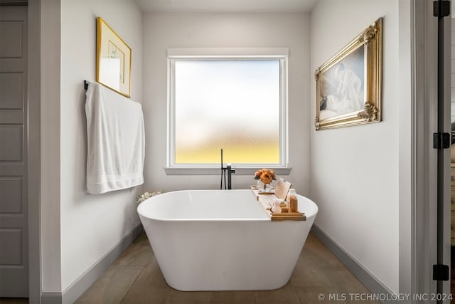 bathroom with tile floors and a bath to relax in