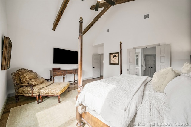 bedroom featuring high vaulted ceiling, beamed ceiling, ceiling fan, and hardwood / wood-style flooring