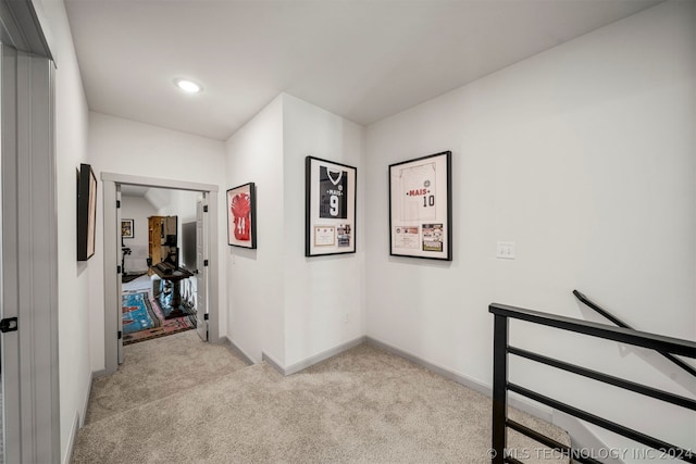 hallway with light colored carpet