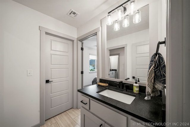 bathroom with tile flooring and vanity