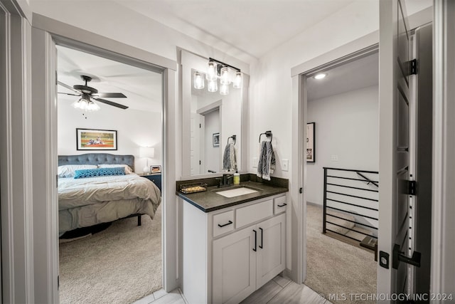 bathroom with ceiling fan and large vanity