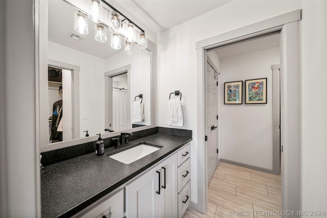 bathroom featuring vanity and tile floors