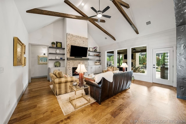 living room with beamed ceiling, high vaulted ceiling, ceiling fan, and light hardwood / wood-style flooring