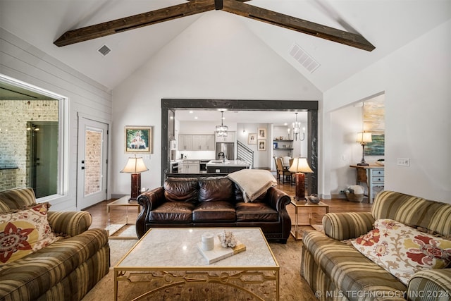 living room featuring beamed ceiling, high vaulted ceiling, and wood-type flooring