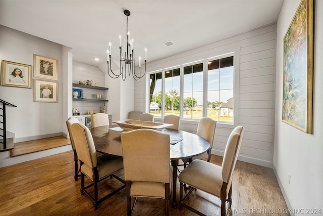 dining room featuring hardwood / wood-style floors and a chandelier