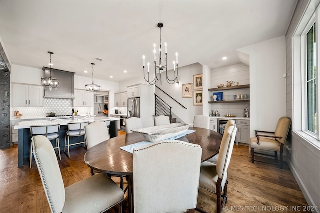 dining room with a notable chandelier and dark hardwood / wood-style floors