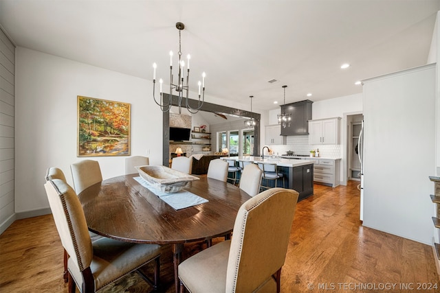 dining room with a notable chandelier and light wood-type flooring