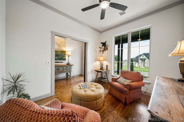 living room with ornamental molding, ceiling fan, and hardwood / wood-style floors