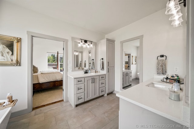 bathroom featuring vanity, tile floors, and a bathtub