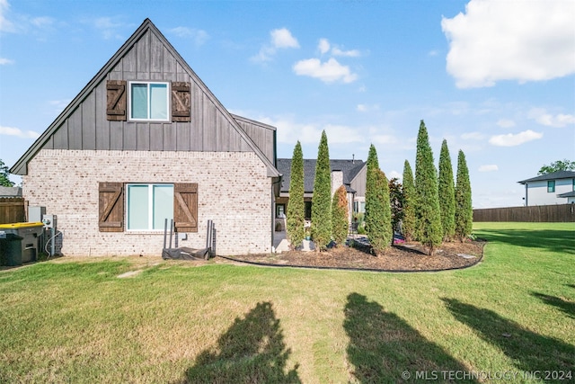 rear view of property with a yard