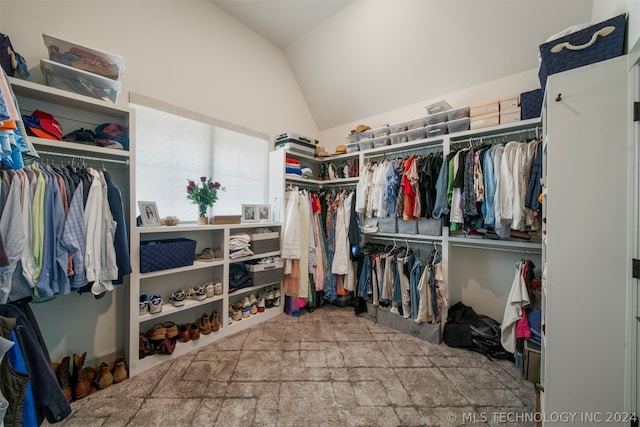 walk in closet featuring lofted ceiling and carpet