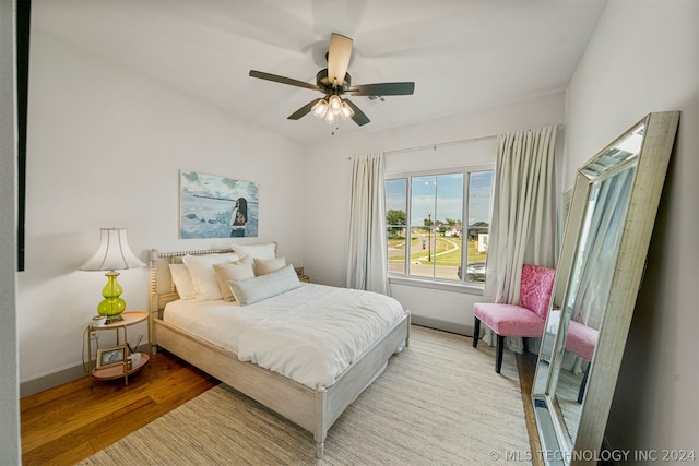 bedroom with ceiling fan and wood-type flooring