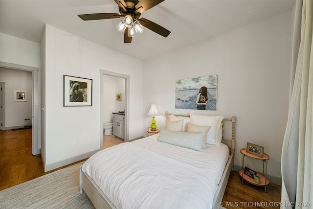 bedroom featuring ceiling fan, connected bathroom, and hardwood / wood-style flooring