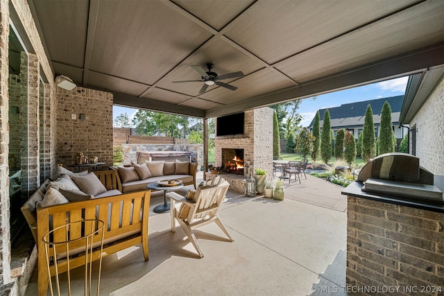 view of patio / terrace featuring an outdoor living space with a fireplace and ceiling fan