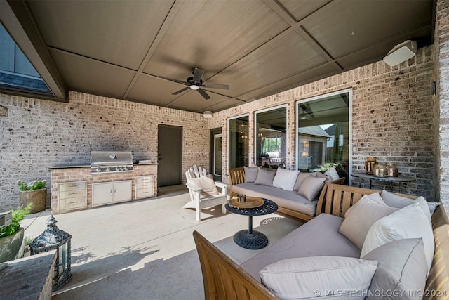 view of terrace featuring ceiling fan, outdoor lounge area, an outdoor kitchen, and area for grilling