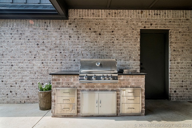 view of terrace with an outdoor kitchen and area for grilling